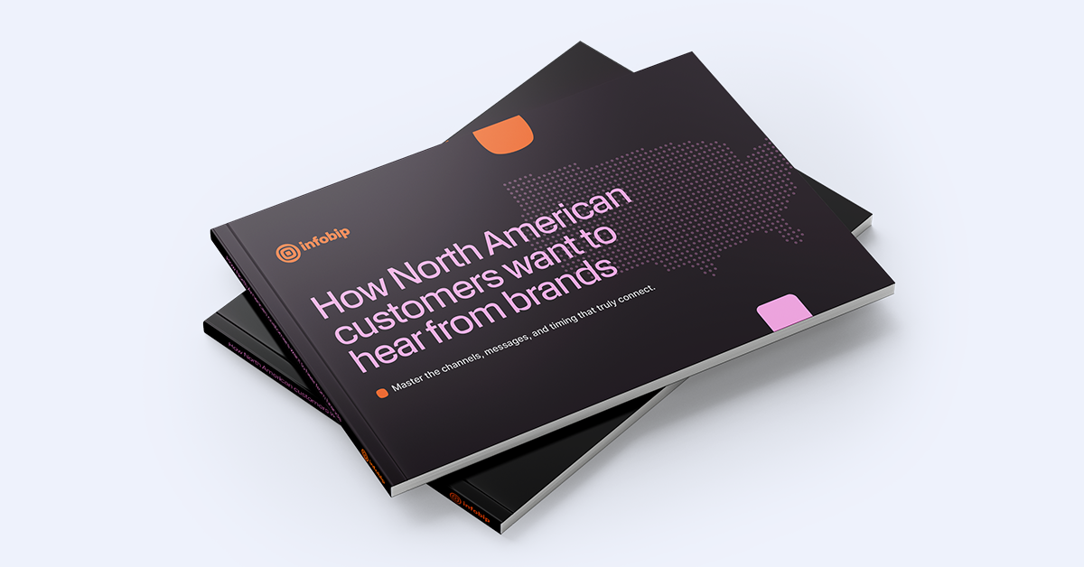 A stack of dark-colored booklets lying on a light surface. The top booklet has the title in large pink letters, “How North American customers want to hear from brands,” with a dotted map outline of the United States next to it. The booklet also features the Infobip logo and tagline “Master the channels, messages, and timing that truly connect.”